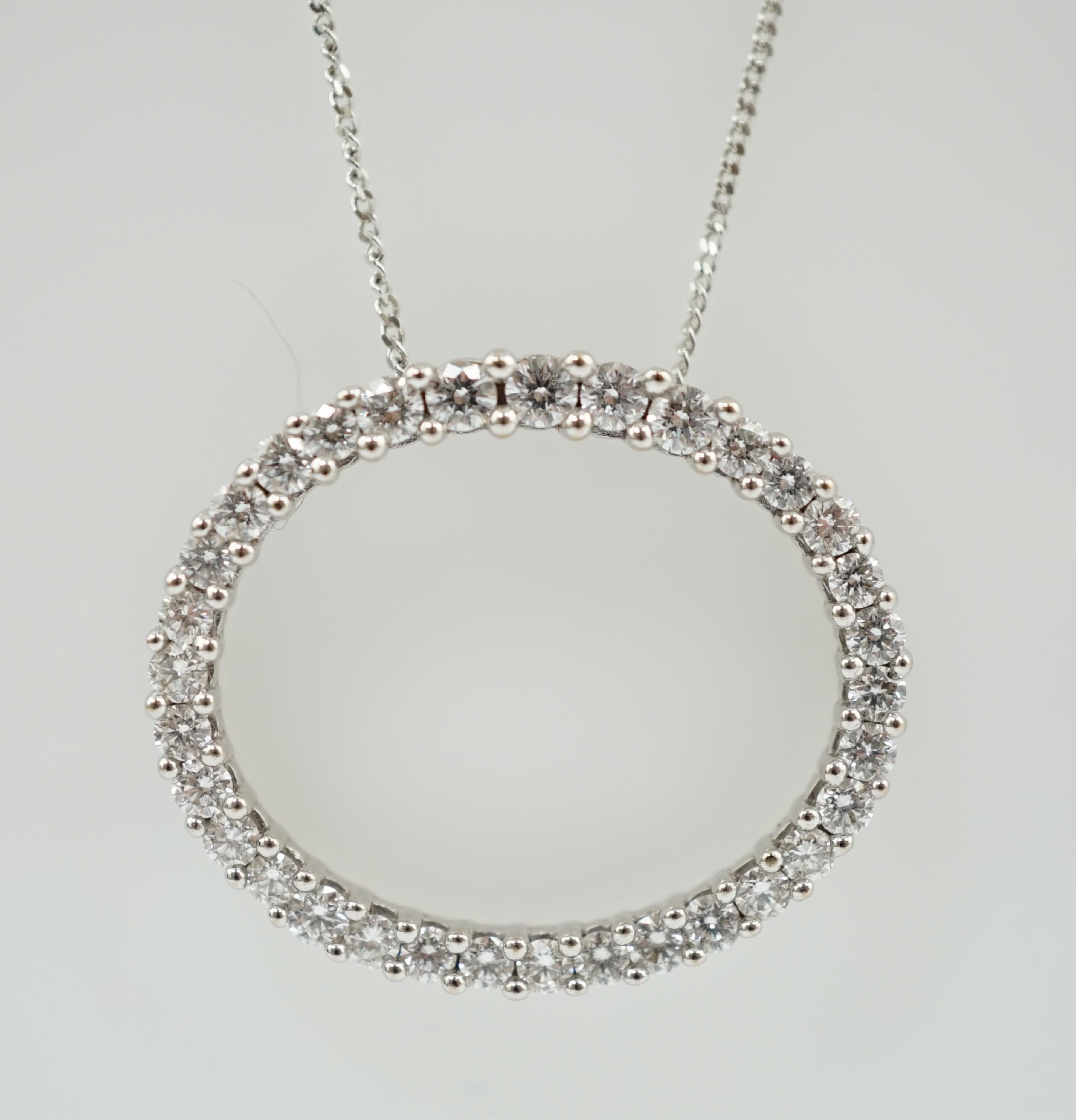 A modern 18k white gold and diamond cluster set open work oval pendant, on an Italian 18k white gold fine link chain